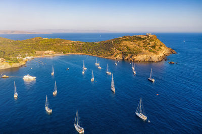 High angle view of sailboats by sea against blue sky