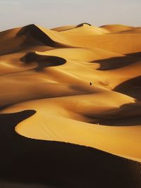 Scenic view of desert against sky during sunset