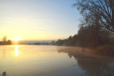 Scenic view of lake against sky during sunset
