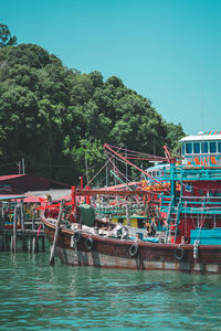 View of boats moored in sea against clear sky