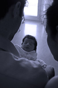 High angle view of parents holding a newborn baby