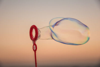 Close-up of bubbles against sky at sunset