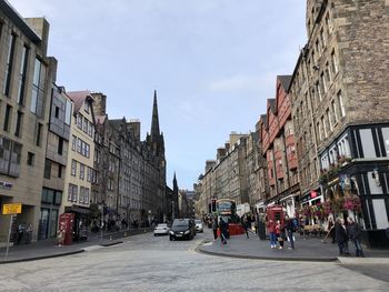 View of city street and buildings against sky