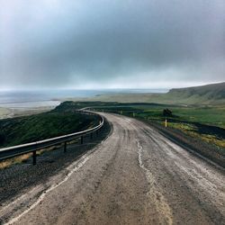 Road by landscape against sky