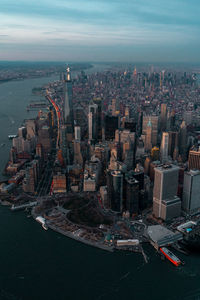 High angle view of buildings by sea against sky