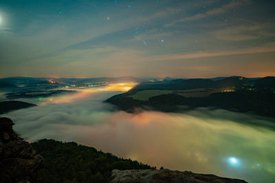 Scenic view of mountains against sky at night 