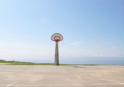 Road sign against sky