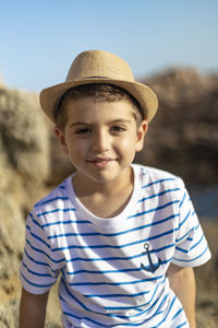 Portrait of boy wearing hat standing outdoors