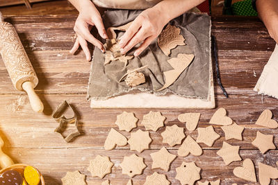 Close-up, two female potters make a lot of christmas toys with the help of forms a christmas tree 