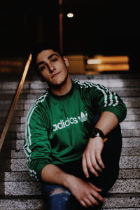 Portrait of young man sitting outdoors