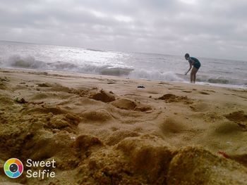 Full length of man on beach against sky