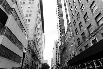 Low angle view of buildings in city against sky