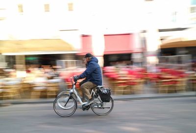 Man cycling on city street