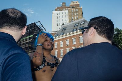 Rear view of people against buildings in city