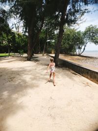 Full length of woman on dirt road