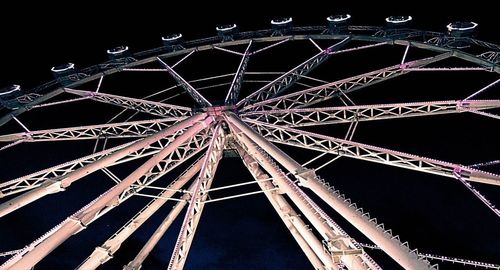 Low angle view of illuminated ferris wheel against sky