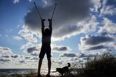 Man with dog standing in background