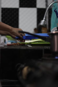 Midsection of woman working in kitchen