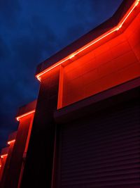 Low angle view of illuminated building against sky at night