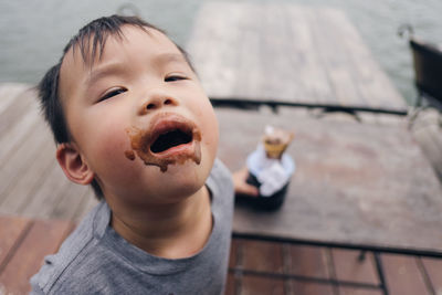 Close-up portrait of messy face of boy with chocolate