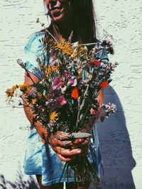 Close-up of young woman holding bouquet