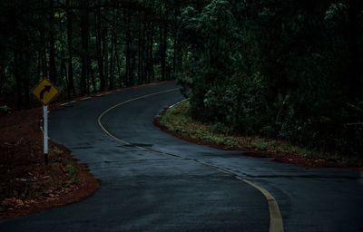 View of empty road amidst trees