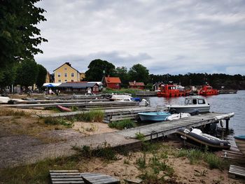 Houses by lake against sky in sandhamn, stockholm archipelago