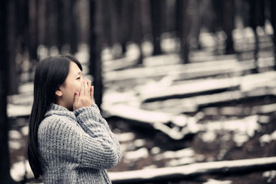Portrait of woman with hand on snow