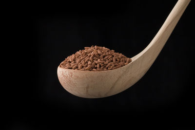 Close-up of bread in bowl against black background