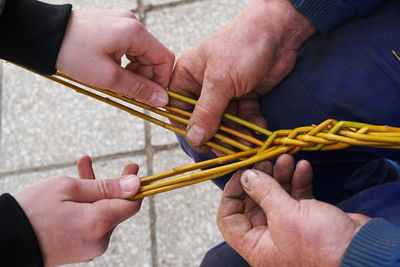 High angle view of people holding sticks outdoors