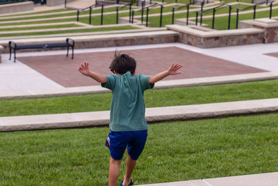 Rear view of boy on field
