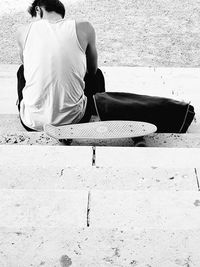 Rear view of boy sitting on floor