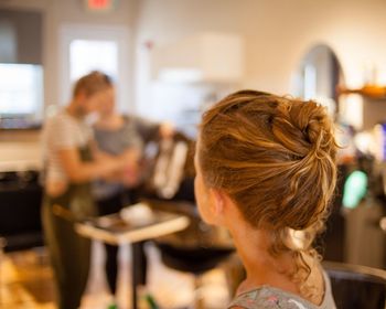 Rear view of women sitting on table