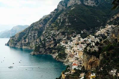 Scenic view of sea by town against sky