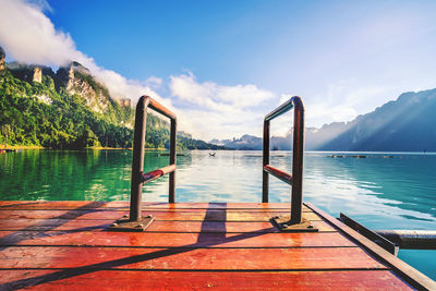 Scenic view of swimming pool by lake against sky