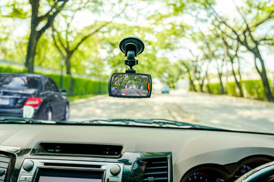 Vintage car on road seen through windshield