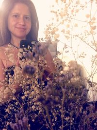 Portrait of smiling young woman with flowers