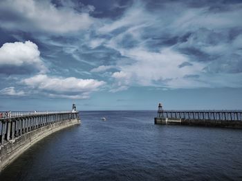 Pier over sea against sky