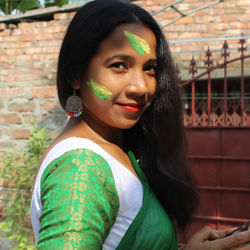 Portrait of beautiful young woman standing outdoors