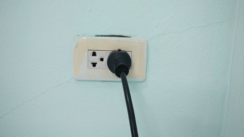 Close-up of electric lamp against wall