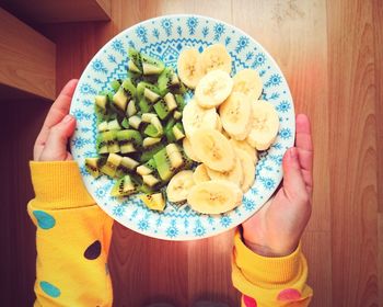 High angle view of person holding breakfast served on table