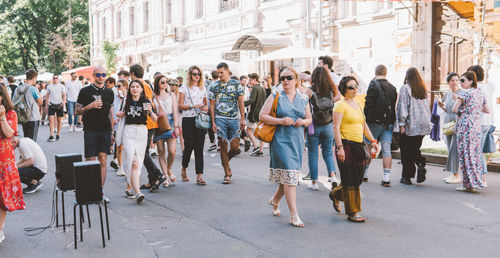 Group of people walking on city street