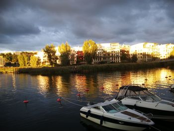 Scenic view of river by trees against sky