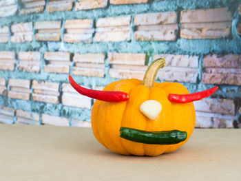 Close-up of pumpkin against wall