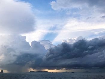 Sunlight streaming through clouds over sea