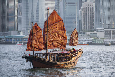 Boat in river with buildings in background