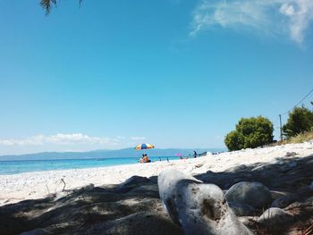 Scenic view of beach against blue sky