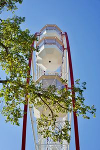Low angle view of tree and building against sky