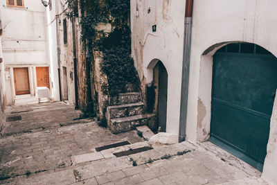 Empty alley amidst buildings in city