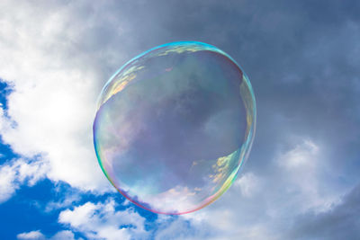 Close-up of bubbles against clouds